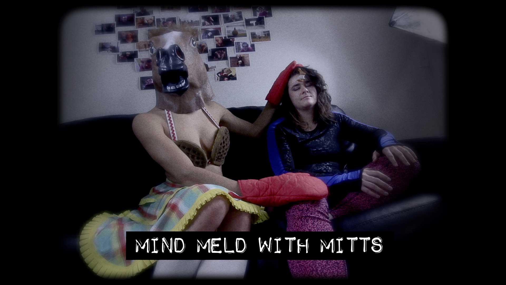 Horse Head sitting on the couch with another character, laying oven-mitted hands on her. Text: Mind Meld With Mitts